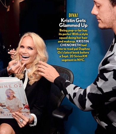 Kristin Chenoweth smiles as she reads a book and poses for the camera backstage at Sirius FM, pictured in People Magazine