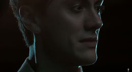 foreboding closeup of a young man, dim, moody lighting