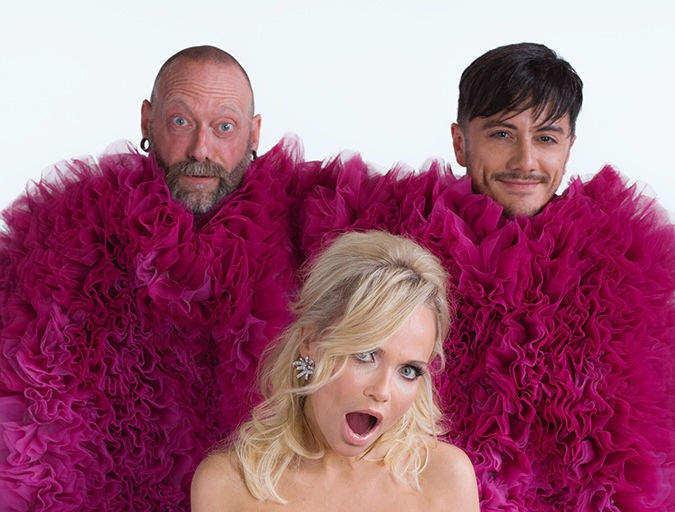 Kristin Chenoweth, Joseph Stanek, and Jonathan Hanousek share a playful moment behind the scenes of The Art of Elegance album photoshoot, emerging from a sea of magenta ruffles by Christian Siriano.