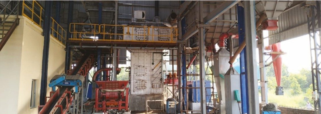 Sand reclamation plant with silos and conveyors inside a foundry