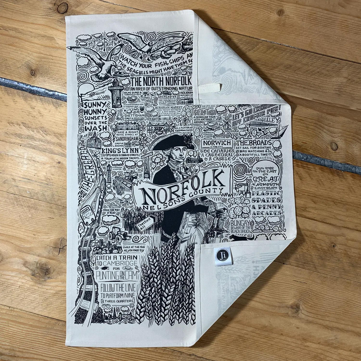 james illustrates tea towel on wooden dining table