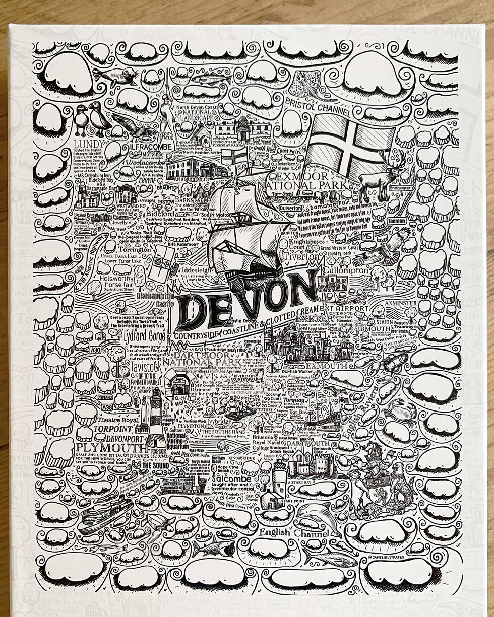 Thumbnail: A James Illustrates Devon jigsaw puzzle close up of the box cover illustration sitting on a wooden dining table
