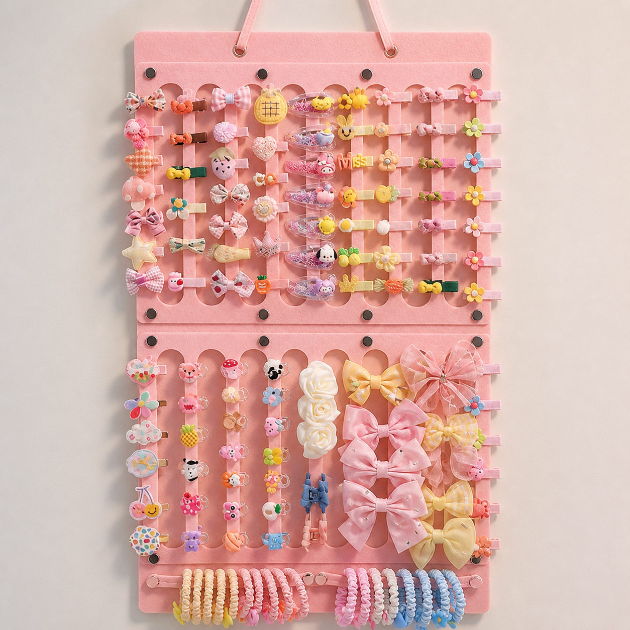Pink two-panel felt organizer displaying illustrative clips, bows and hair ties