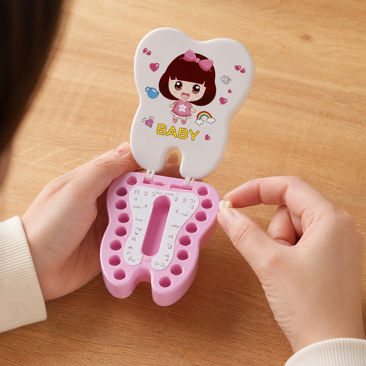 Baby Tooth Box Organizer Kids Milk Teeth Storage — close overhead view of adult placing one cleaned keepsake into an individual compartment, hands accurate