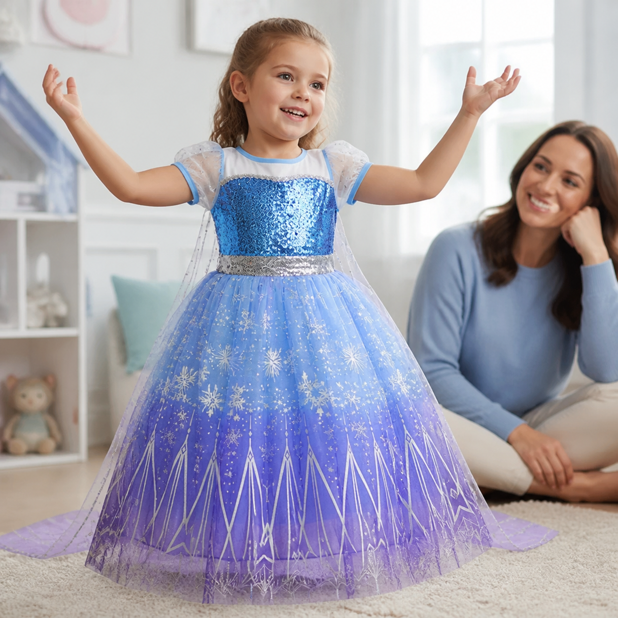 Child confidently wearing the blue-to-lavender snowflake princess dress while an adult watches