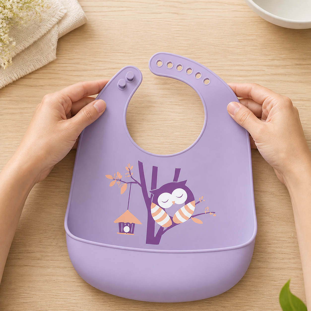 Purple Owl silicone bib laid flat with six adjustment holes and two fastening buttons visible
