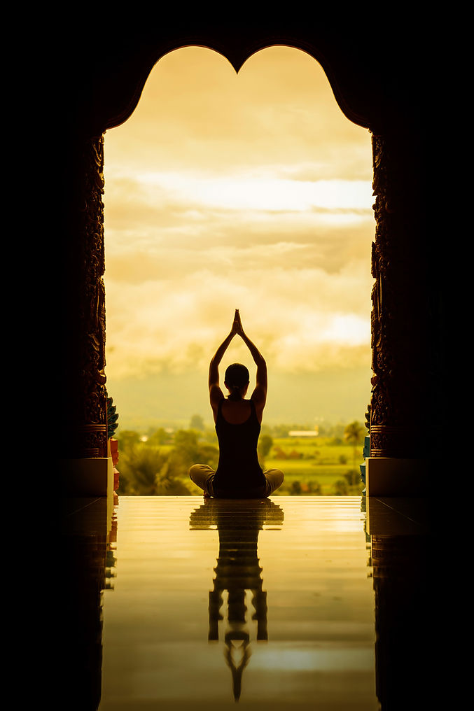 Yoga woman sitting in lotus pose on the temple during sunrise to reflection in floor, vint