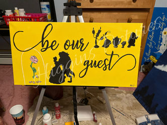 "be our guest" script with character silhouettes and rose in vase.