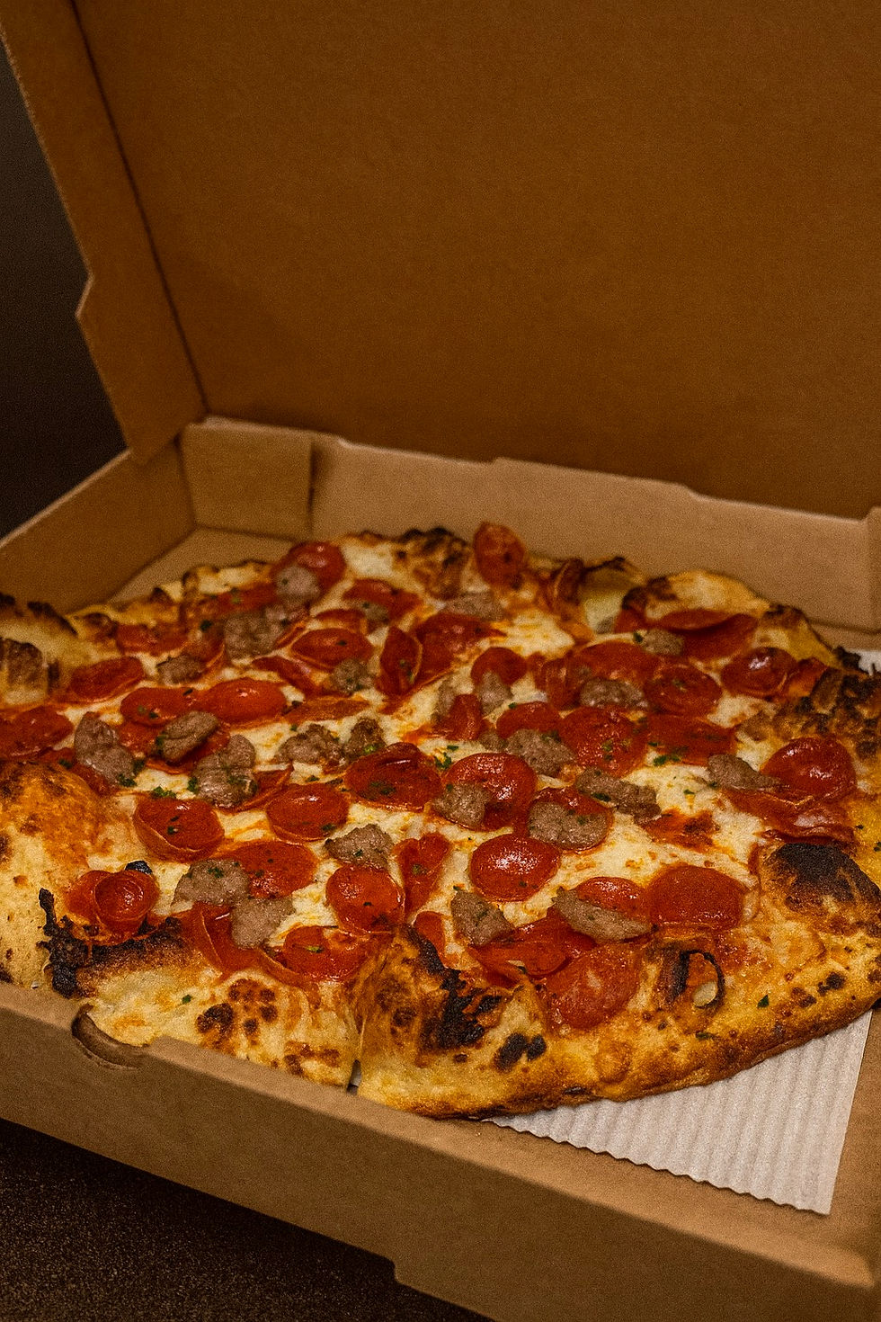 Pepperoni and Sausage Pizza in Takeout Box