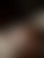 Newborn baby with hand up on soft blanket