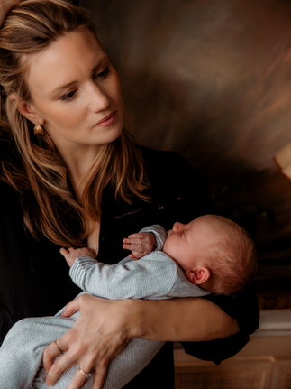 Newborn baby in mother's arms