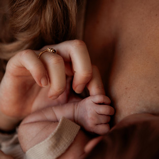 Details photo of mother holding her newborn's hand