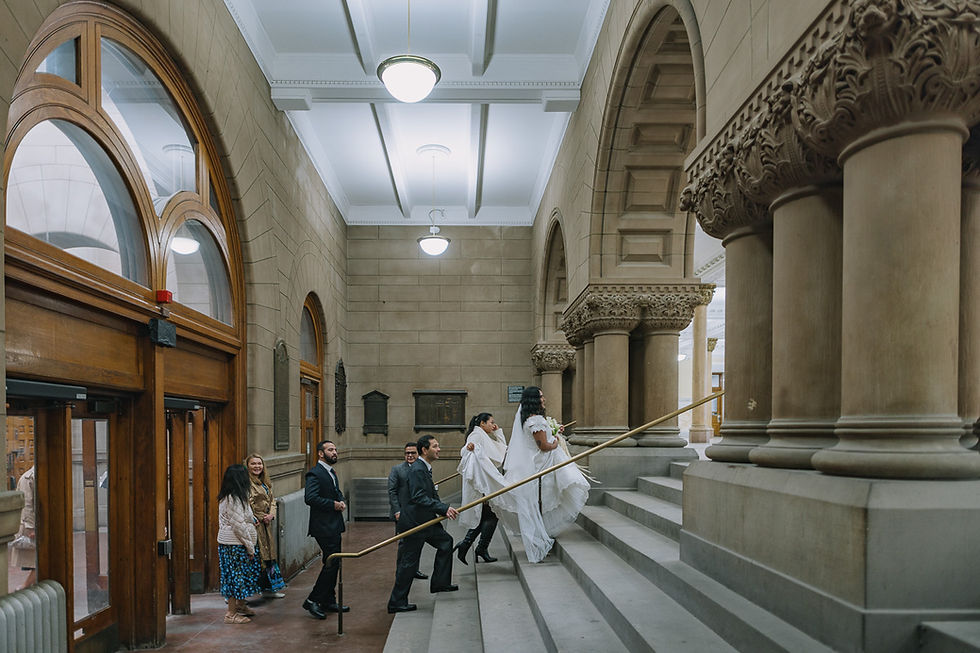The grand, historic stone staircase and architecture inside Old City Hall Toronto, a classic spot for wedding photos.