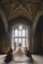 An epic bridal portrait of a bride looking out a grand, architectural window at a unique Toronto wedding venue