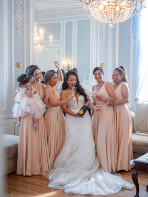 Bride and bridesmaids celebrating in a luxury bridal suite