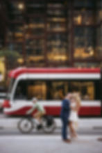 couple kissing downtown toronto during engagement session with streetcar in background