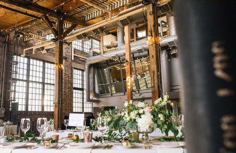 Empty Steam Whistle Brewery reception space showing historic Douglas fir beams and large multi-paned windows.