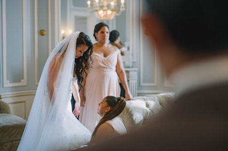 Candid Toronto wedding photography of a bride surrounded by her bridesmaids sharing an emotional moment during morning preparations.