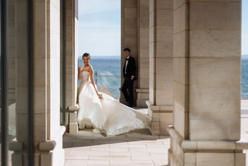 Burlington Wedding Photographer groom looking at bride dress flowing wind lake