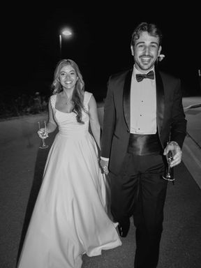 Modern candid black and white wedding photography of a bride and groom laughing together at their Toronto reception.