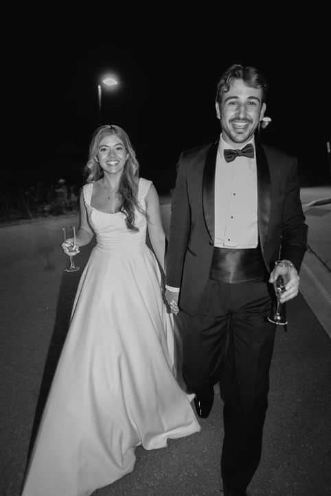 Modern candid black and white wedding photography of a bride and groom laughing together at their Toronto reception.