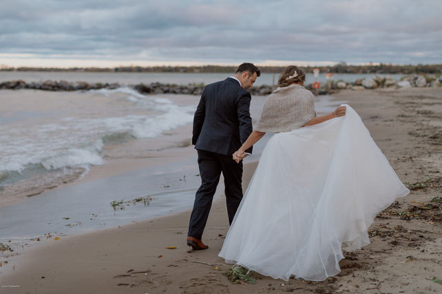 bride and groom walking on beach dress