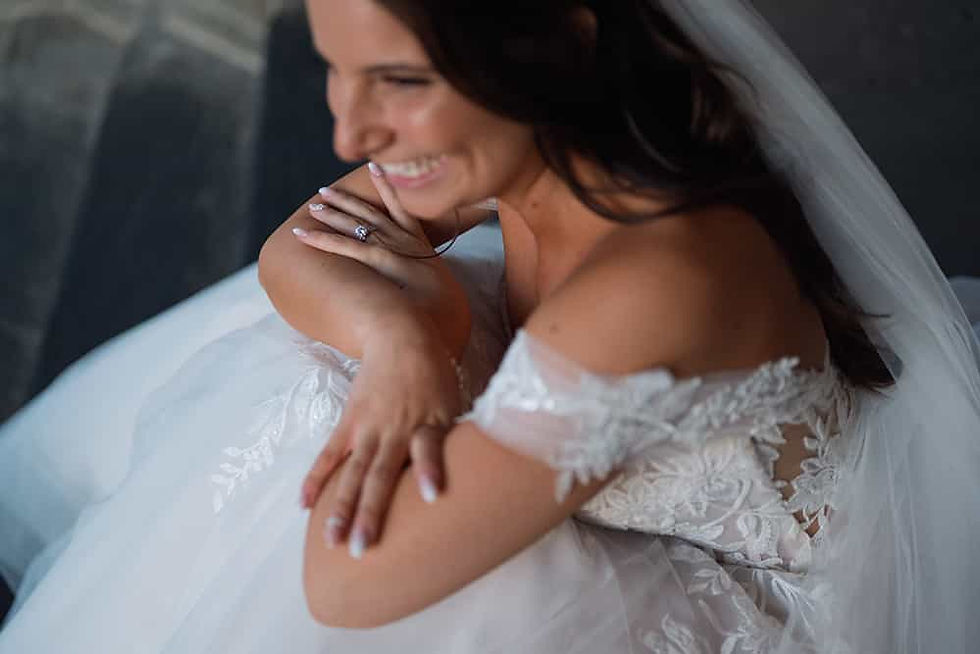 Candid bridal portrait of a smiling bride sitting in her wedding dress out front of Casa Lomaillustrating a 5-star Google review for Lucas T Photography.