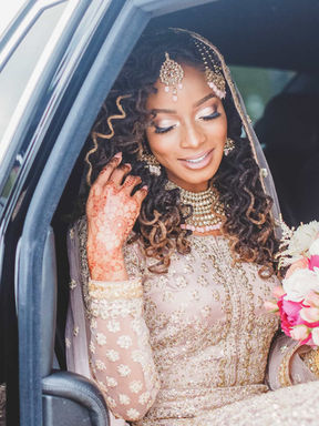 South Asian bride in a car looking out the window