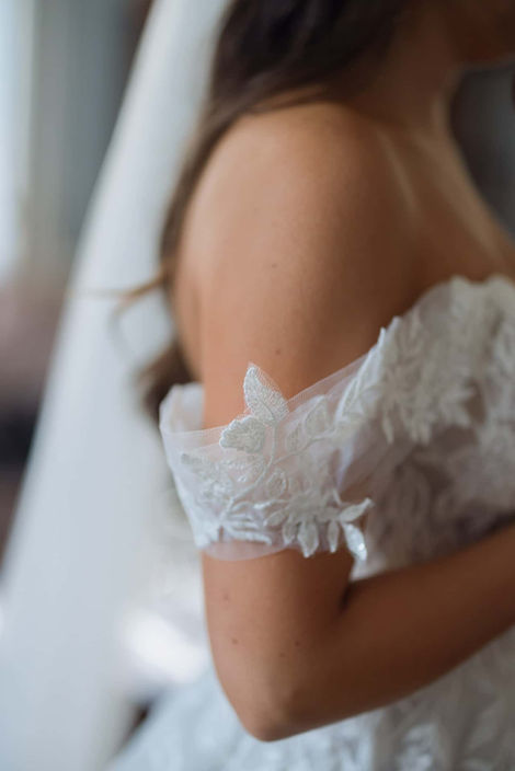 Detail of a lace wedding dress off-the-shoulder sleeve
