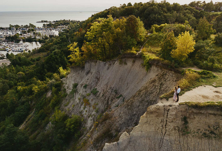 couple next to cliff during engagement session in Toronto Bluffs