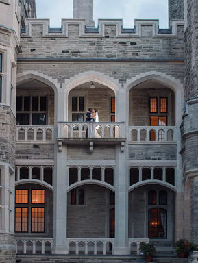 Grand editorial group portrait of a wedding party standing in front of a majestic, classical-style Toronto manor.