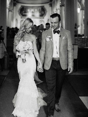 Black and white photo of happy bride and groom walking back down the aisle after their Toronto ceremony