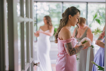 Candid lifestyle wedding photography of bridesmaids in pink dresses preparing for a ceremony at the Estates of Sunnybrook.