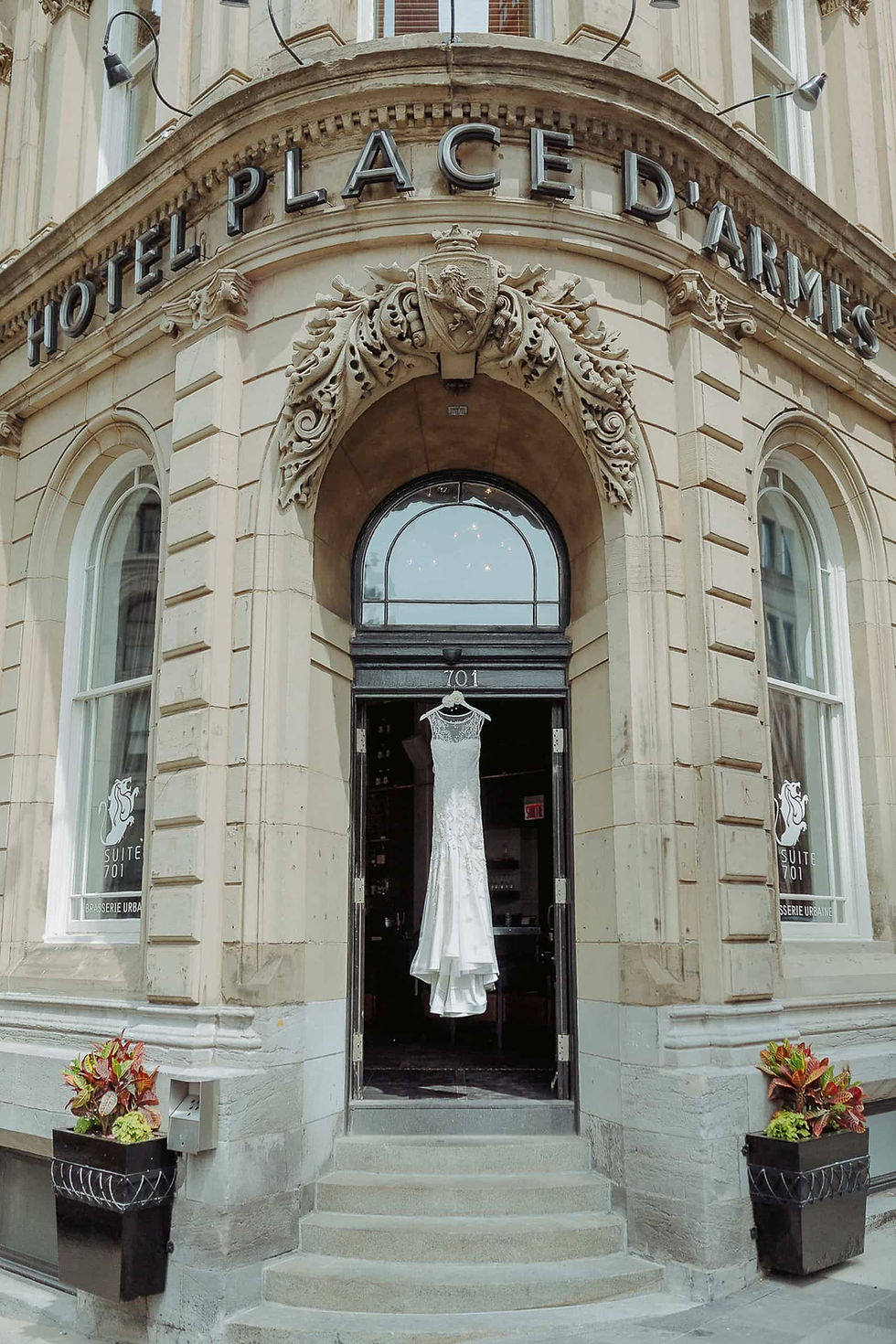 Wedding dress hanging at Hotel Place D'Armes doorway. toronto wedding photographer