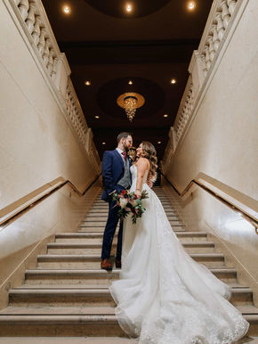 Detailed architectural photography of the historic stone masonry and arched windows of the One King West building.