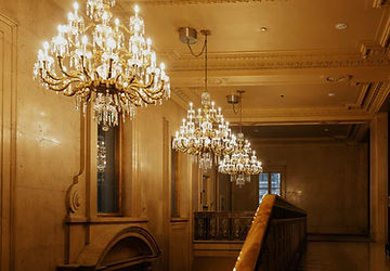 Opulent gold chandelier and historic interior details at One King West