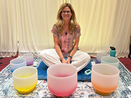 Photo of sound healing practitioner Jen Boulanger with crystal singing bowls