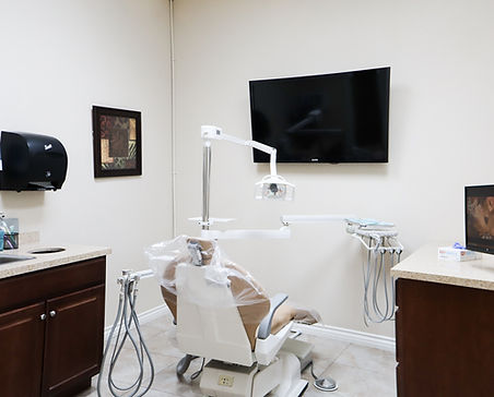 Welcoming examination room in our dentist office featuring a dental chair and TV.