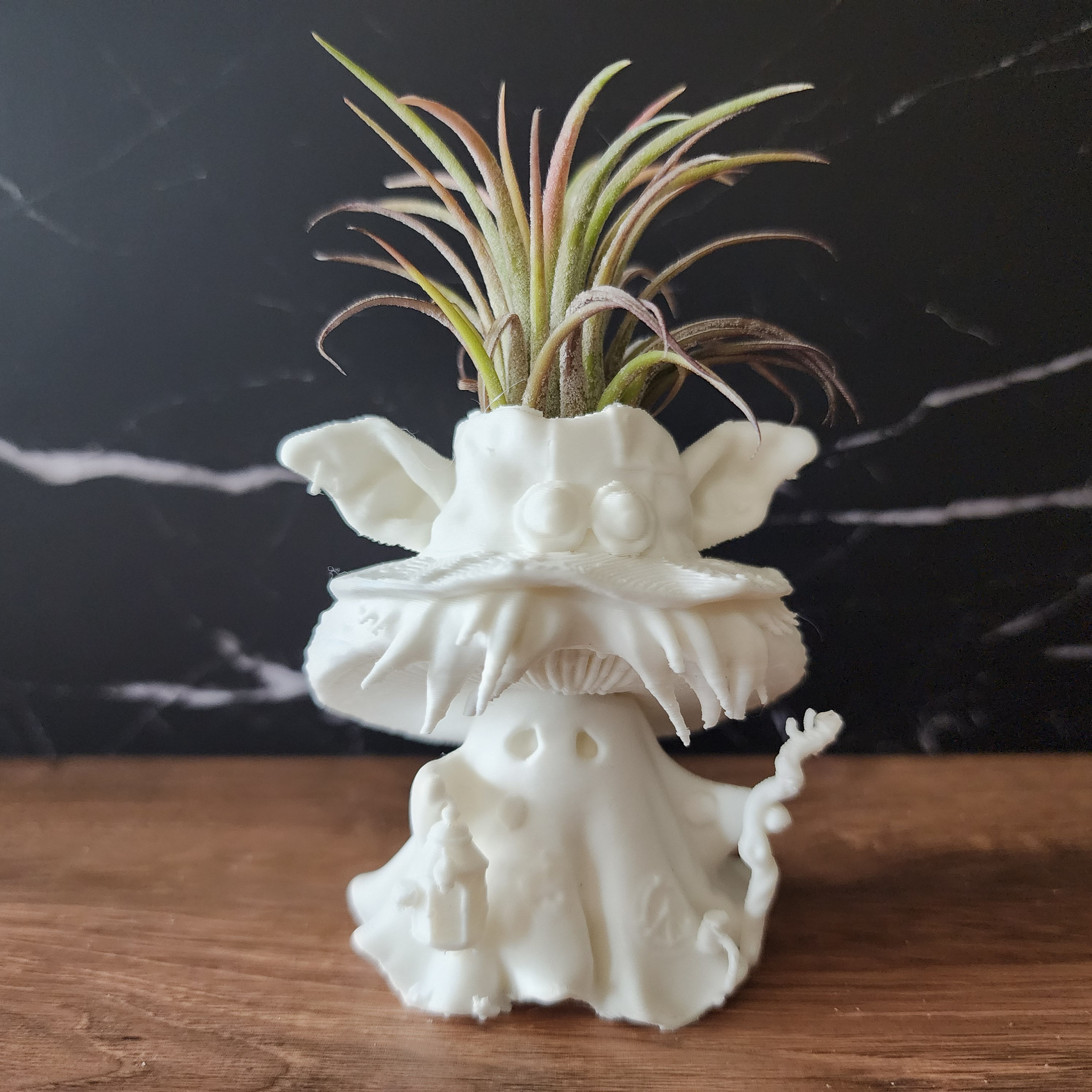 Mosswick white Bloom Sprite with mushroom-creature hat, crooked staff and living air plant