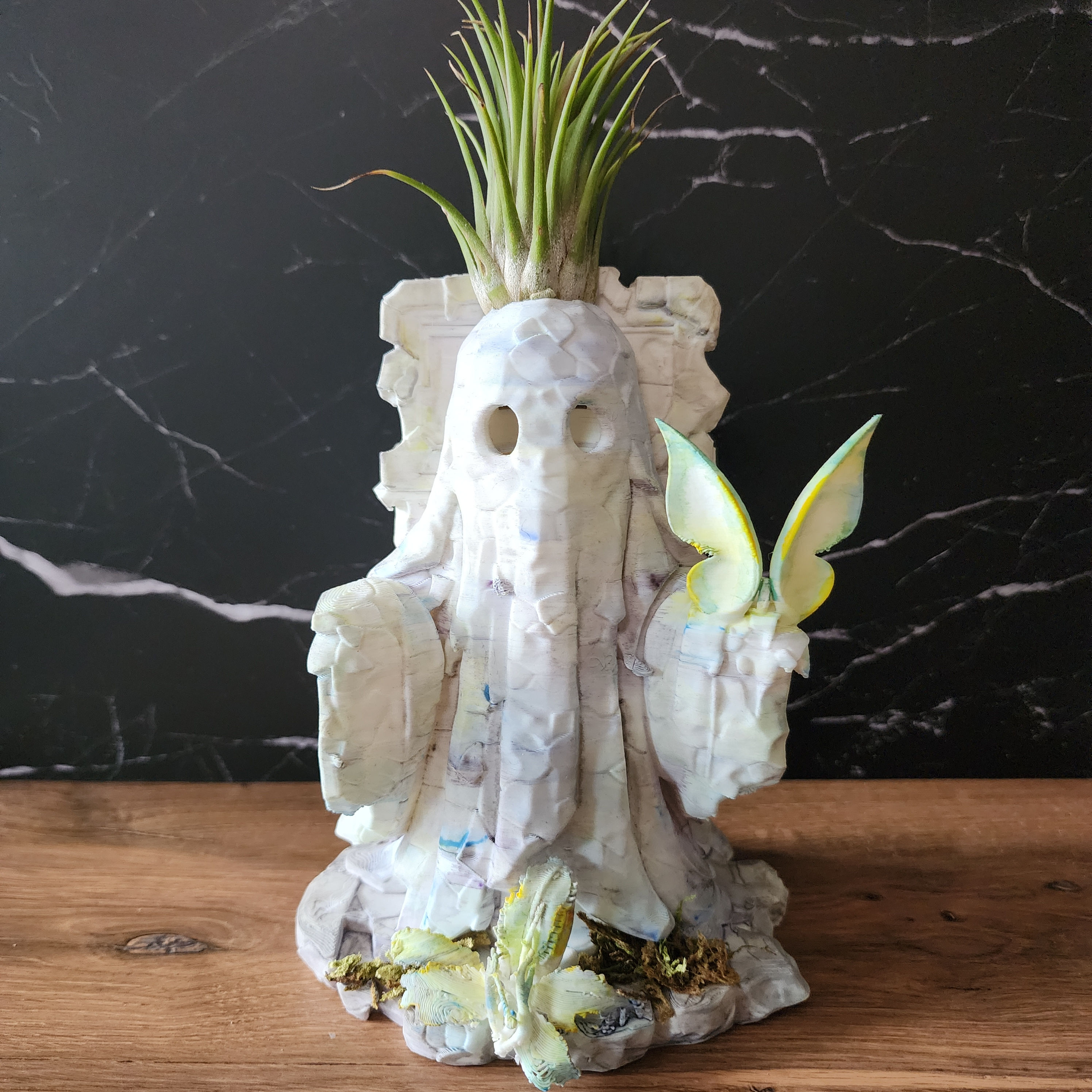 Thren 001 6 inch ancient ghost with hollow black eyes and living air plant against black marble