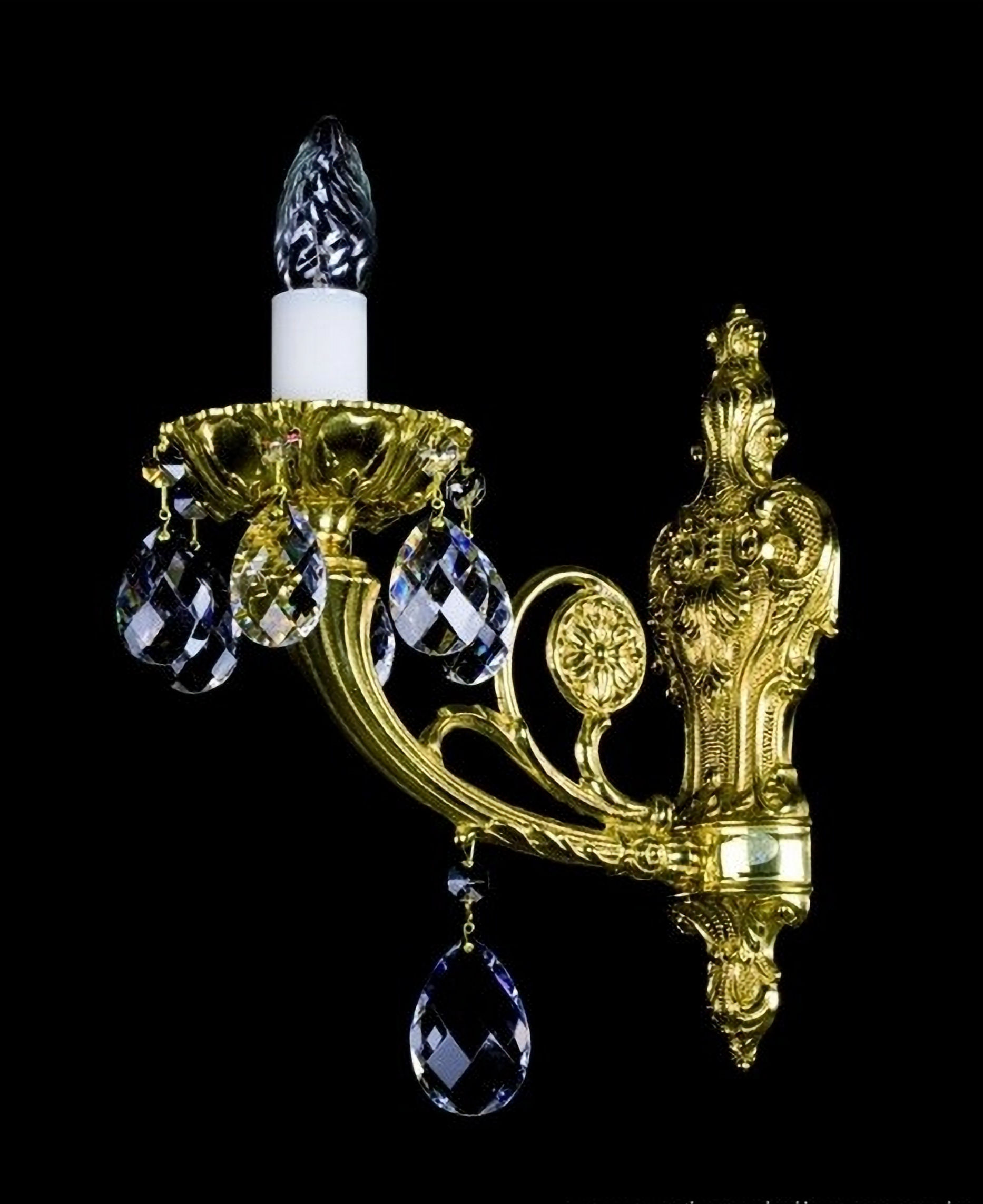 Livia, a cast brass wall sconce, features a finely detailed ornate frame adorned with 30% PbO crystals.