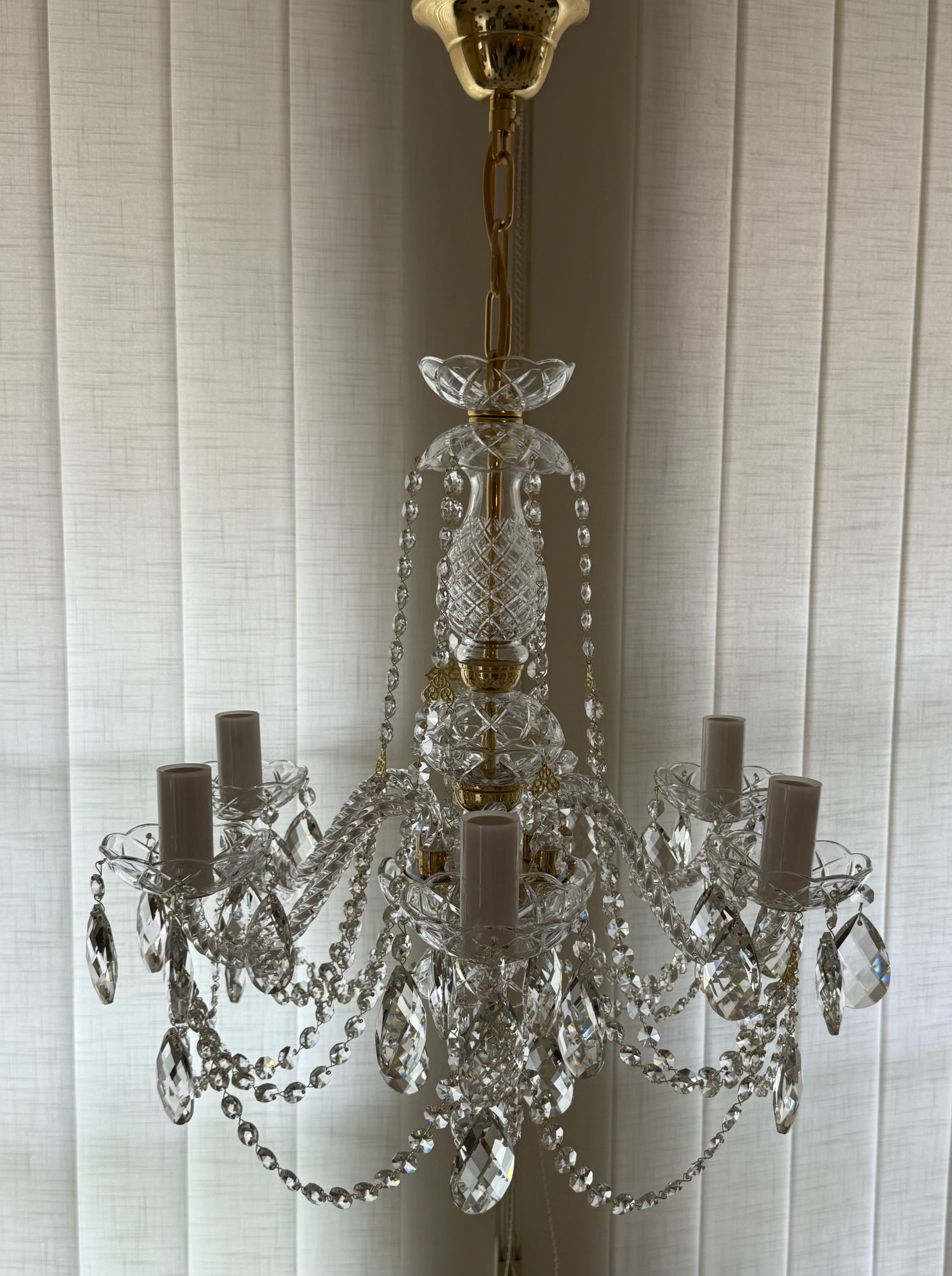 Angelina is a captivating Bohemian crystal chandelier featuring rope twist glass arms and elegant oval crystals. Gold Finish.