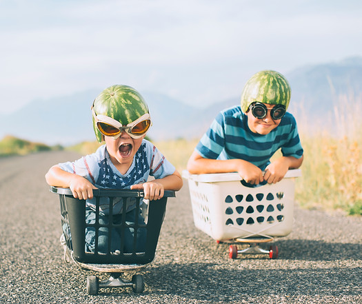 Young Boys Racing Wearing Watermelon Helmets