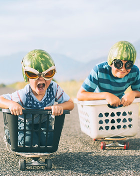 Young Boys Racing Wearing Watermelon Hel
