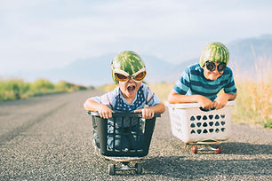 Young Boys Racing Wearing Watermelon Helmets