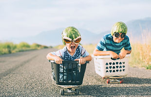 Young Boys Racing Wearing Watermelon Helmets