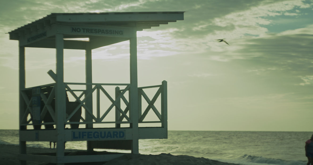 Weathered lifeguard stand on a beach at dusk