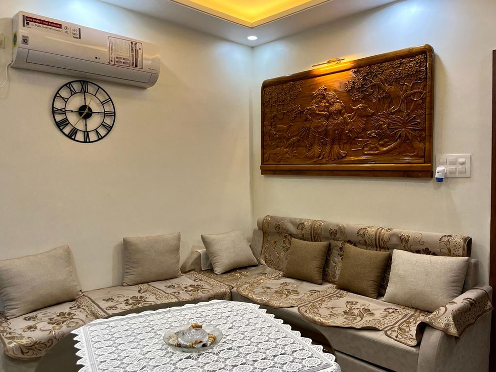 Traditional living room interior with warm tones and wooden décor in Katara Hills Bhopal home.