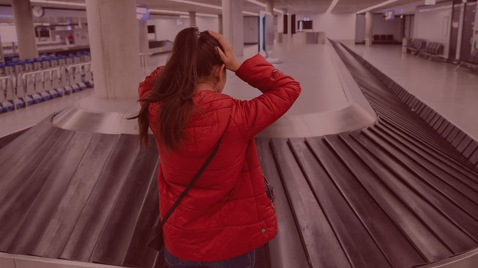 Mulher olhando para a esteira de malas no aeroporto, mas sua mala não chegou