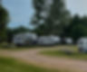 Travel trailers and campers at an RV park and campground.